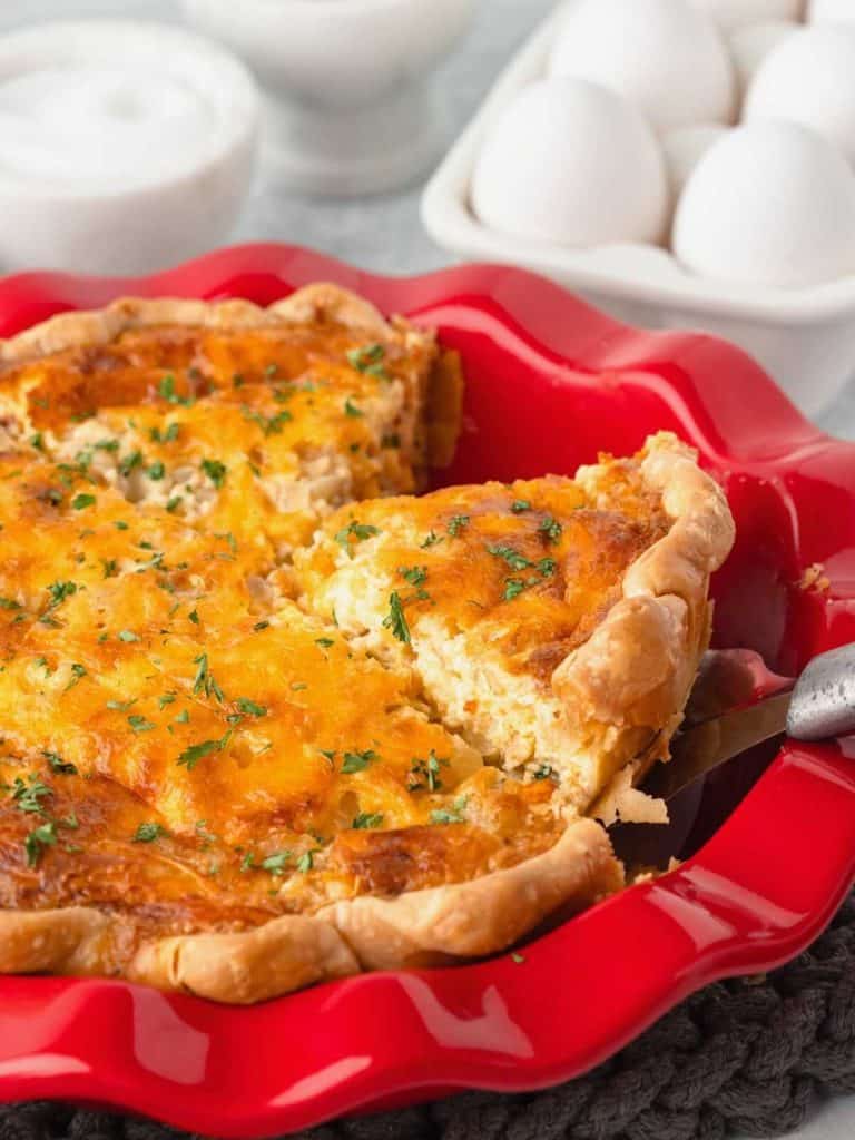 server lifting up slice of quiche